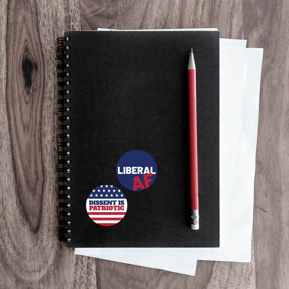 liberal and dissent stickers on a notebook